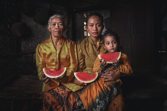 2nd place winner - "This photograph was captured during my trip to Blitar, East Java Indonesia. I was travelling to a small village named Kampung Nusantara. That day when I was walking around the village, I met Mbok Sutinah, 82 years, a grandma who's been selling watermelon since 1987 after her husband passed away to support her family."
