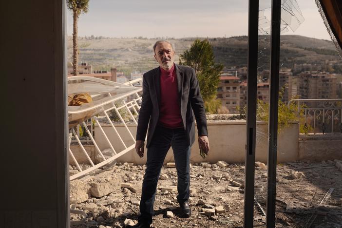 Ghassan Mamouli, a representative from the Damascus government, inspects the damage at the site of an Israeli airstrike on Thursday.