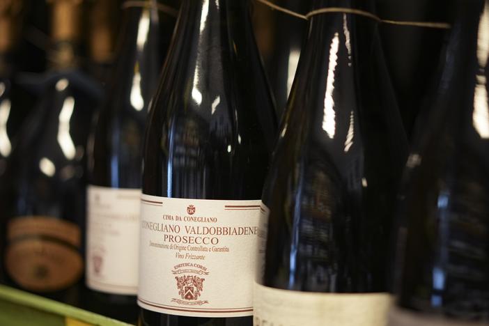 Bottles of Prosecco are lined up on a shelf of a wine shop in Rome last month. Trump's threatened 200% tariffs, if they go into effect, could impact products like imported Prosecco, French champagne and Spanish wine.