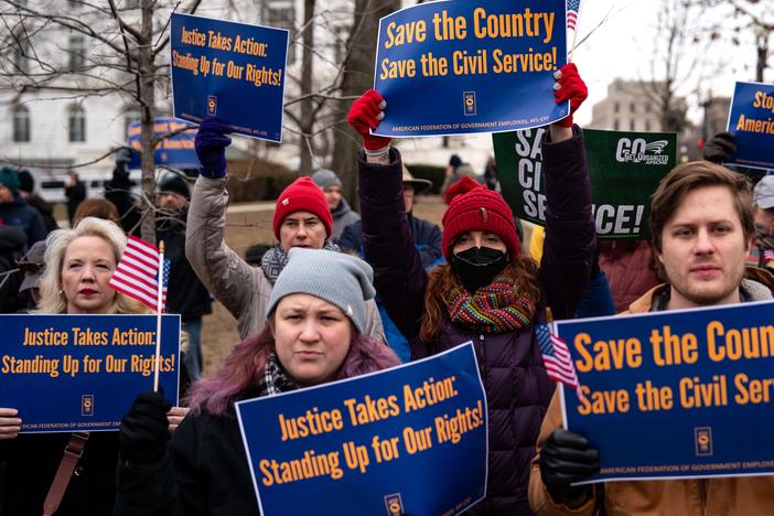 People hold signs during a "Save the Civil Service" rally outside the U.S. Capitol on Feb. 11, 2025 in Washington, D.C.