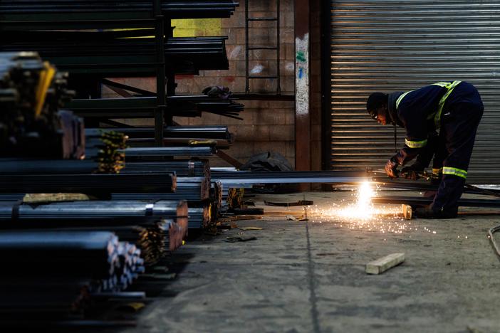 A worker cuts a piece of steel for a customer at North York Iron, a steel supplier in Toronto, Ontario, Canada, Feb. 11.