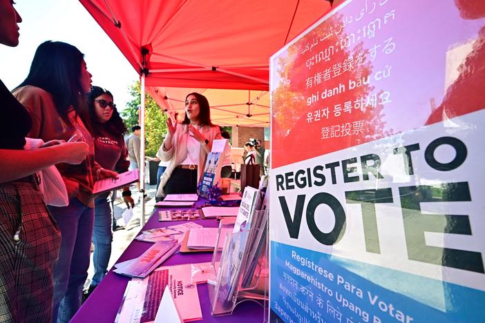 Potential young voters get information at a voter registration desk at California State University, Los Angeles, on Oct. 22, 2024. The Republican-backed SAVE Act would add documentary proof-of-citizenship requirements to voter registration.