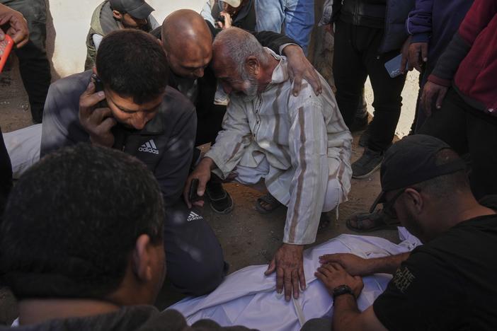 Palestinians mourn over the bodies of their relatives killed by an Israeli airstrike in Beit Lahiya, northern Gaza Strip on Saturday. The Israeli military says it was targeting "terrorists" operating a drone in the area. But the head of Gaza's civil defense, Mahmoud Basal, says they were aid workers from the London-based Al Khair Foundation, along with two journalists working with the group.