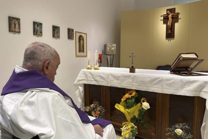 In this photo released by the Vatican, Pope Francis is seen praying inside Rome's Gemelli Hospital on Sunday.