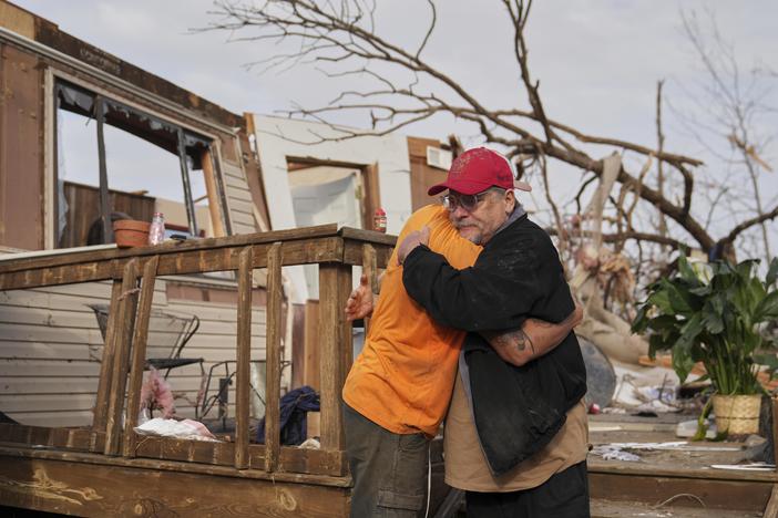 Tim Scott, right, gets a hug from friend Jorden Harris outside Scott's home he was inside when it was destroyed during a severe storm the evening before Saturday, March 15, 2025, in Wayne County, Mo.
