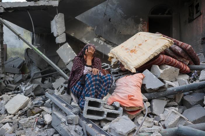 A woman cries while sitting on the rubble of her house, destroyed in an Israeli strike, in the Nuseirat refugee camp in central Gaza Strip on Tuesday. Israel on Tuesday unleashed its most intense strikes on the Gaza Strip since a January ceasefire.