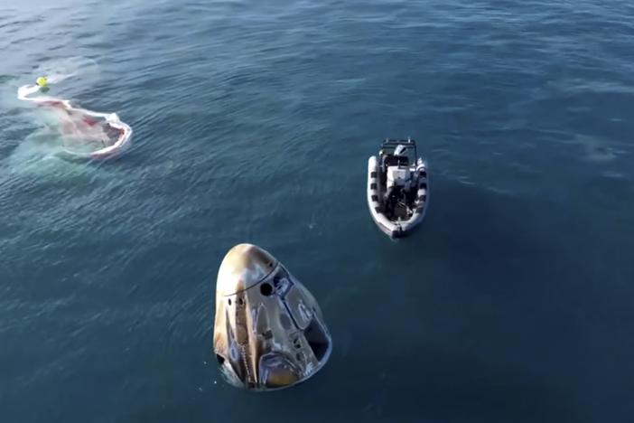 In this image taken from video provided by NASA, a SpaceX capsule floats in the Gulf of Mexico, Tuesday, March 18, 2025, after landing off the coast of Florida with NASA astronauts Suni Williams, Butch Wilmore and Nick Hague, and Russian cosmonaut Alexander Gorbunov.