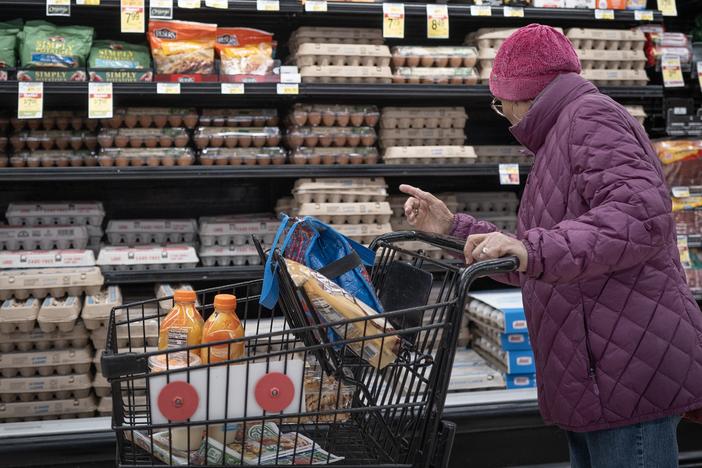 A customer shops for eggs at a  grocery store on March 12 in Chicago. Wholesale egg prices are going down, but it could take several days before grocery prices follow suit.