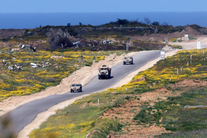 In this picture, taken from Israel's southern border with the Gaza Strip, Israeli soldiers patrol a street in northern Gaza on Wednesday. The Israeli military says it's launched a new ground offensive in Gaza, a day after Israel broke a ceasefire with a punishing series of airstrikes that killed more than 400 people.