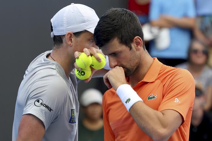 Canada's Vasek Pospisil and Serbia's Novak Djokovic talk tactics during their double match against during their Round of 32 match at the Adelaide International Tennis tournament in Adelaide, Australia, Jan. 2, 2023.