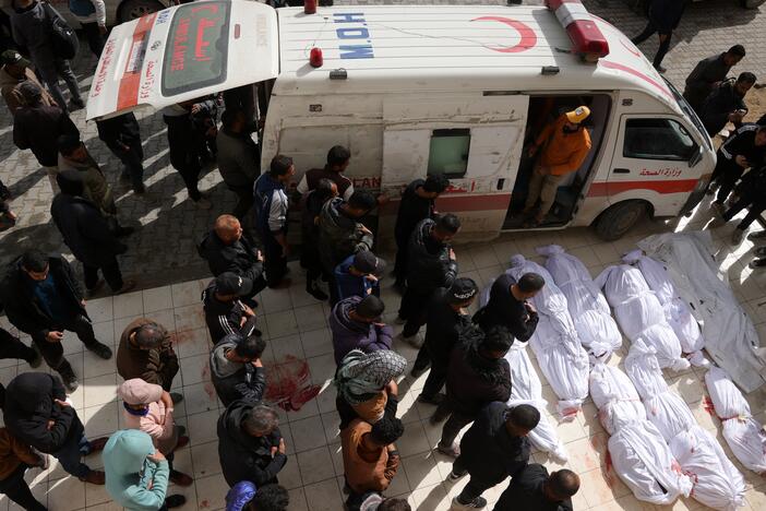 Palestinians recite a prayer over the bodies of victims of Israeli overnight airstrikes in the northern Gaza Strip, in front of the Indonesian Hospital in Beit Lahia on Thursday.