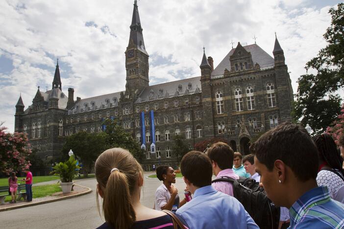 In this July 10, 2013, file photo, prospective students tour Georgetown University's campus in Washington.