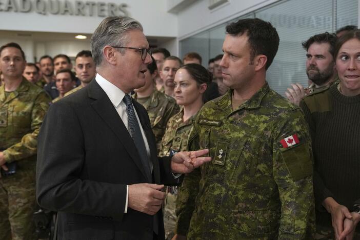Britain's Prime Minister Keir Starmer speaks to a Canadian Lt Colonel as he visits a military base to meet planners mapping out next steps in the Coalition of the Willing in Northwood, London on Thursday.