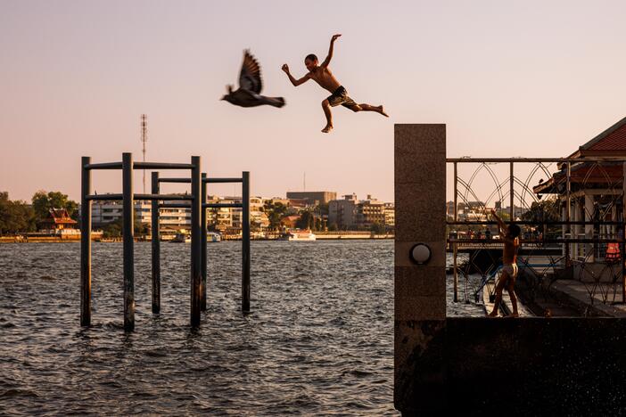 The boy and bird are, of course, not really flying together. But ... they are both airborne. The child is jumping into the Chao Phraya river in Bangkok, Thailand, during a heatwave in February 2024. Photographer Andre Malerba notes: "This image recalls the free feeling of leaping from several times one's height into water to escape the heat as friends laugh and cheer you on. A time many of us might remember as when we felt truly whole and at peace, even if life wasn't perfect. It's always worth realizing t…