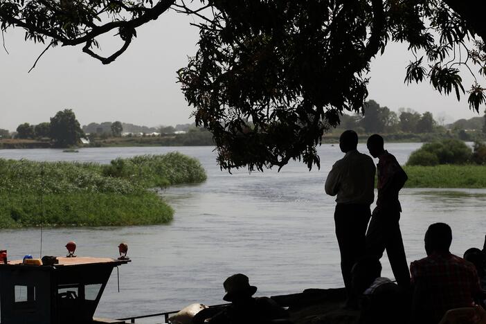 Southern Sudanese who have returned to the south by barges  stand on the banks of the Nile river in Juba's port on Jan. 10, 2011.