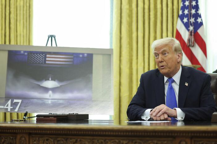 President Trump speaks as an image of an F-47 fighter jet is displayed in the Oval Office in Washington on Friday.