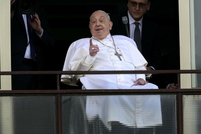 Pope Francis gestures as he appears at a window of the Agostino Gemelli Polyclinic in Rome on Sunday.