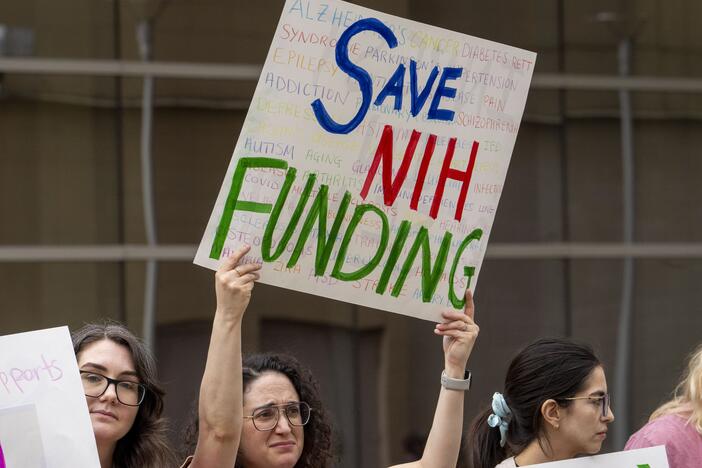 A protestor in Houston, Texas, holds a sign in favor of funding from the National Institutes of Health on March 7 during a "Stand Up for Science" rally at the Houston Medical Center.