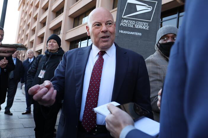 Louis DeJoy, the outgoing U.S. postmaster general, speaks to reporters in 2022 in Washington, D.C. On Monday, he announced that he is stepping down.