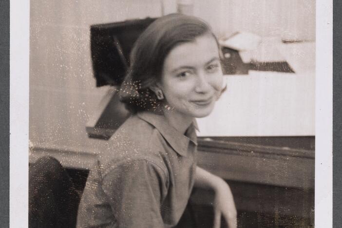 Photograph of Joan Didion in the Vogue Art Department, c. 1958