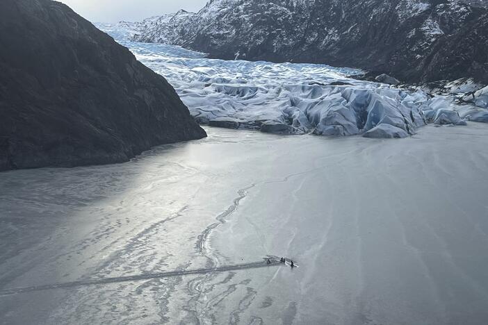 This photo provided by the Alaska National Guard shows an airplane partially submerged into the ice of Tustumena Lake at the toe of a glacier on Monday, March 24, 2025, near Soldotna, Alaska. (Alaska National Guard via AP)