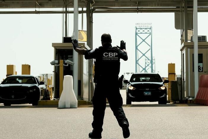 U.S. Customs and Border Protection agents direct vehicles re-entering the U.S. from Canada at the Ambassador Bridge Port of Entry in Detroit.