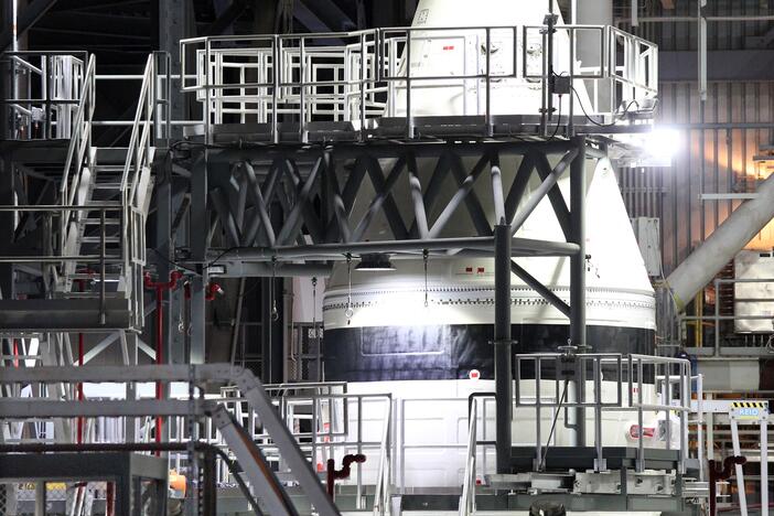 NASA engineers work alongside the tip of a solid rocket booster for the Artemis II Space Launch System (SLS) in NASA's Vehicle Assembly Building at the Kennedy Space Center in Florida in February.