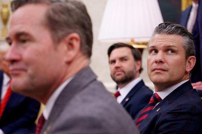 President Trump, National Security Adviser Michael Waltz, Vice President Vance and Defense Secretary Pete Hegseth listen to a question from a reporter during a meeting in the Oval Office on March 13.
