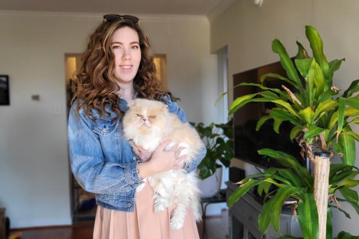 Susan Burke is trying to sell her extra Beyoncé tickets on StubHub, but they are not showing up for most users. In this photo, Burke is posing with her cat, Peaches.