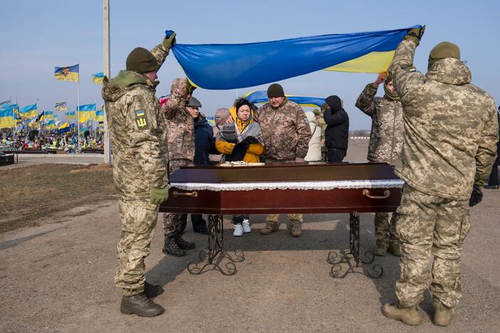 Stanislava Lisovska, 40, (center left) stands at her husband Andrii Ruban's casket (who was killed at 41 years old) with soldiers from his unit, as they bury him in Odesa in February. Ruban a new father when Russia launched its full-scale invasion of Ukraine in February 2022, but like many in those early days, he volunteered to join the army and had been fighting ever since.