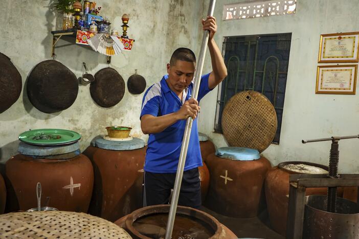 Phan Cong Quang makes fish sauce in his home in Nam O fishing village on March 4.