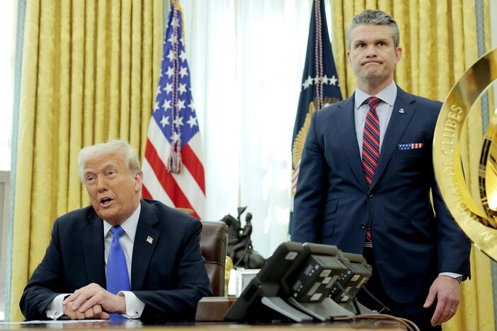 President Trump speaks alongside Secretary of Defense Pete Hegseth in the Oval Office on March 21. Days earlier, Hegseth shared details about overseas war plans in a group chat on Signal, an encrypted, open-source messaging app, according to <em>The Atlantic</em>.