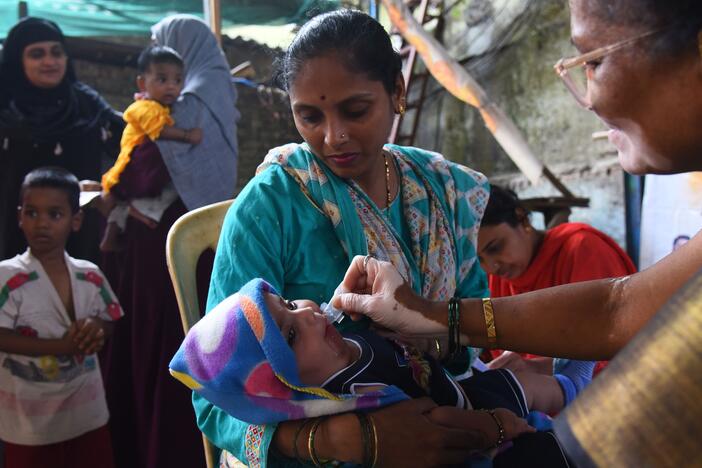 A health care worker administers a measles vaccine to a child at a temporary vaccination camp following an outbreak in Mumbai. India is among the countries that get vaccination support from Gavi, the Vaccine Alliance, whose USAID funding has been terminated.