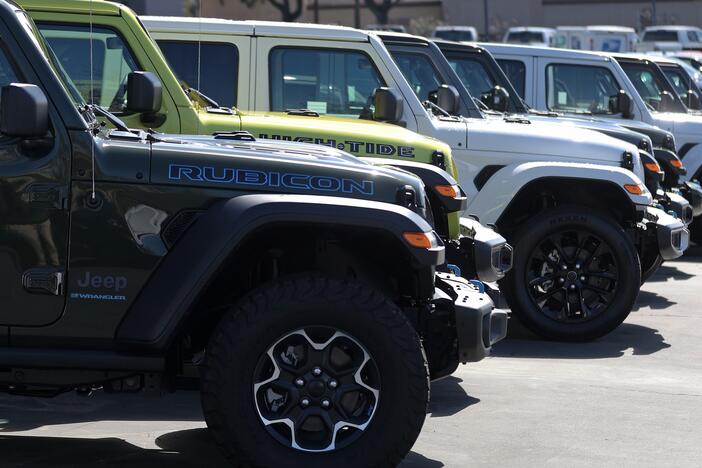 Jeep Wrangler 4Xe plug-in hybrids displayed on the sales lot at Hilltop Chrysler Jeep Dodge Ram in Richmond, California.