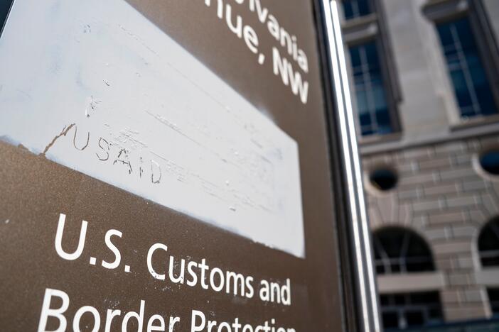 "USAID" is etched onto a covering where signage used to be at the U.S. Agency for International Development's headquarters in Washington, D.C.