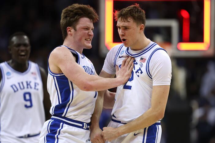 Cooper Flagg, right, and Kon Knueppel of the Duke Blue Devils react after Flagg scored a three-point basket to end the first half against the Arizona Wildcats in the East Regional Sweet 16 round of the NCAA Men's Basketball Tournament at Prudential Center on March 27, 2025 in Newark, New Jersey.