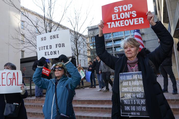 Demonstrators raise signs at a rally to protest the closing of the Consumer Financial Protection Bureau last month in Washington, D.C.