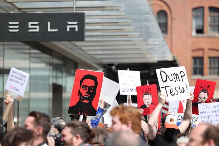 Demonstrators rally against Tesla CEO Elon Musk during a "Tesla Takedown" protest outside a Tesla store in New York City on Saturday.