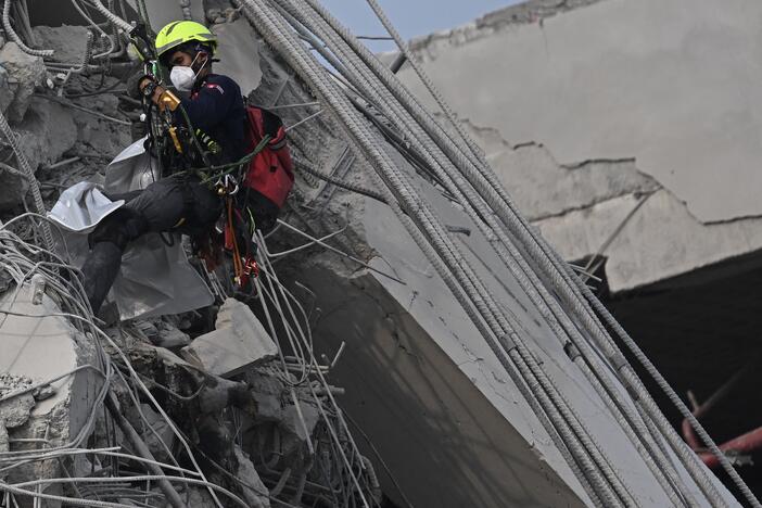 A rescue worker descends  at the site of an under-construction building collapse in Bangkok on March 30, 2025, two days after an earthquake struck central Myanmar and Thailand.