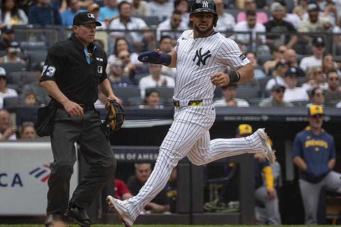 New York Yankees' Jasson Domínguez (24) scores during the third inning of a baseball game against the Milwaukee Brewers, Saturday, March 29, 2025, in New York.