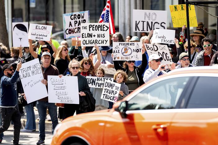Protesters rally against Tesla CEO Elon Musk outside a Tesla store in San Francisco on Saturday.