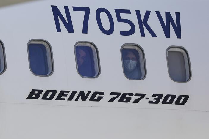 Venezuelan migrants deported from the United States peer through windows of an Eastern Airlines plane upon arriving at Simon Bolivar International Airport in Maiquetia, Venezuela, on Sunday, March 30, 2025.