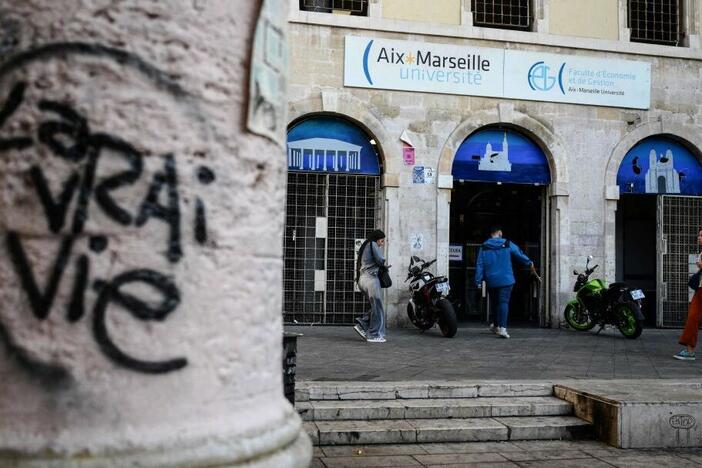 People walk past the faculty of economy of the Aix-Marseille University in Marseille on Oct. 4, 2023.