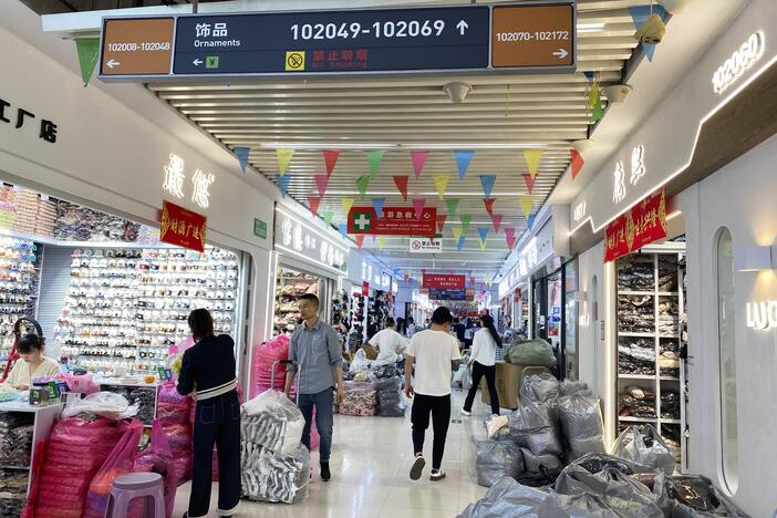 People walk through a building in Yiwu International Trade City, a massive wholesale market in Yiwu, China, where millions of Chinese-made items are sold.