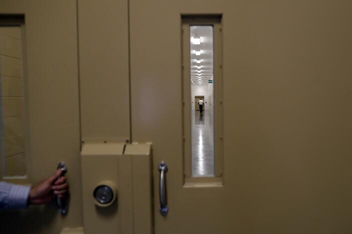 A man walks in a hallway at the Otay Mesa Detention Center Wednesday, Aug. 23, 2017, in San Diego.