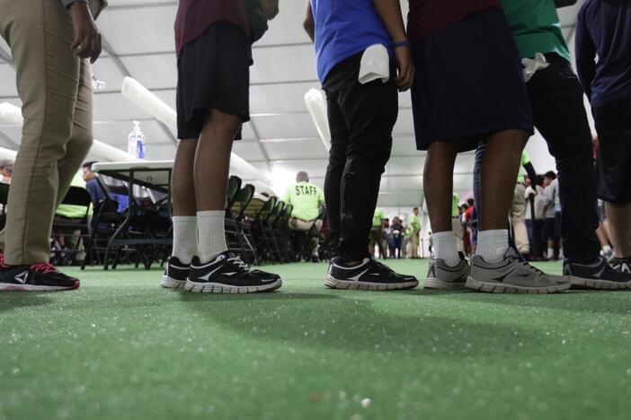 Immigrants line up in the dining hall at a U.S. government holding center for migrant children, July 9, 2019, in Carrizo Springs, Texas.