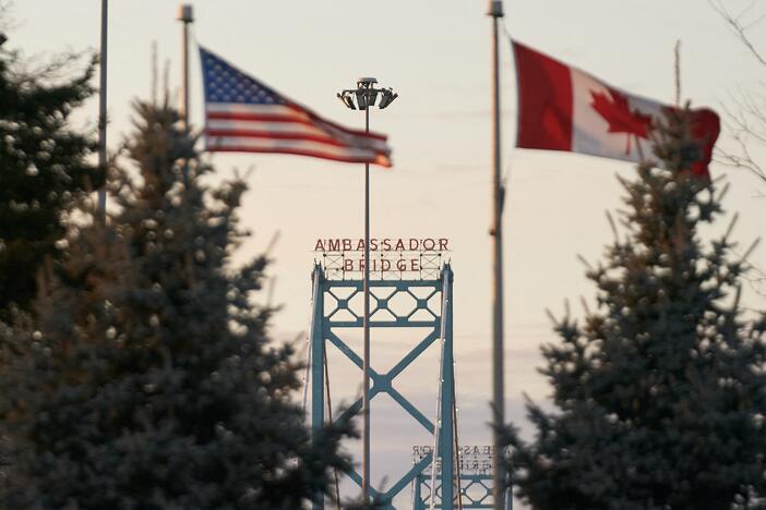 Canadian and American flags fly on the Canadian side of the Ambassador Bridge in Windsor, Ontario, on March 8 after President Donald Trump imposed vast tariffs on key partners Canada and Mexico, roiling cross-border ties before offering temporary relief to manufacturers.