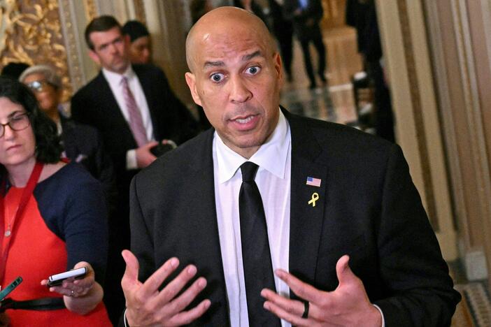 Sen. Cory Booker, D-N.J., speaks to journalists at the Capitol on Tuesday. Booker obliterated a record long held by the late Strom Thurmond, speaking out for more than 25 hours in protest against President Trump's actions since taking office in January.