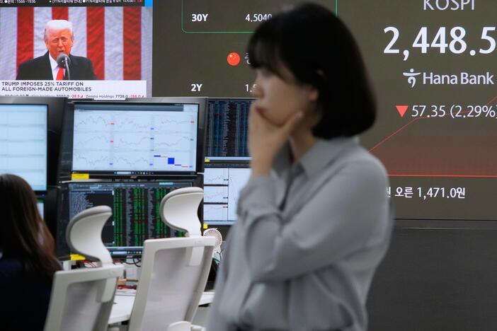 U.S. President Donald Trump is seen on a screen as a currency trader works at the foreign exchange dealing room of the KEB Hana Bank headquarters in Seoul, South Korea, Thursday, April 3, 2025.