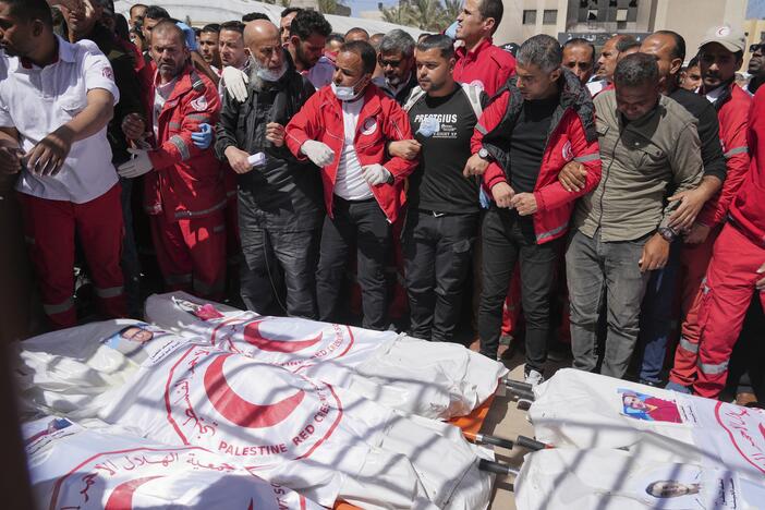 Mourners gather around the bodies of eight Red Crescent emergency responders, recovered in Rafah a week after an Israeli attack, as they are transported for burial from a hospital in Deir al-Balah, Gaza Strip, March 31.